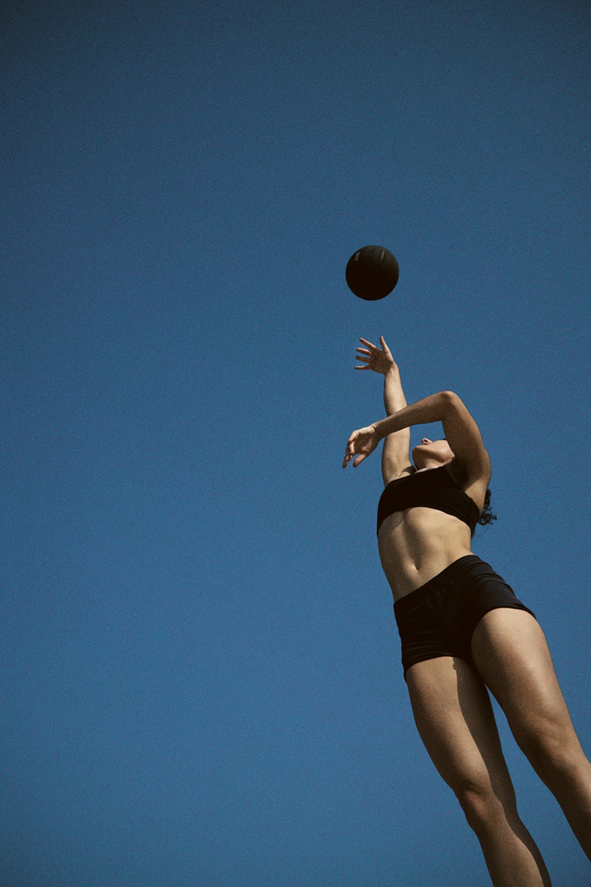 AFTN founder reaching toward a basketball against the sky